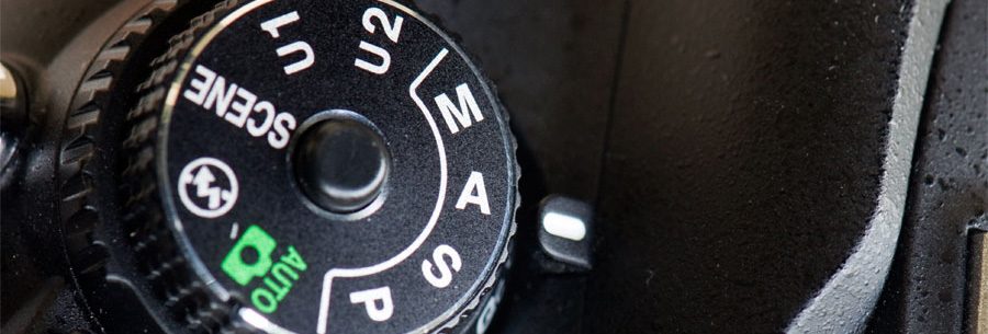 Camera exposure mode dial on a Nikon D610.