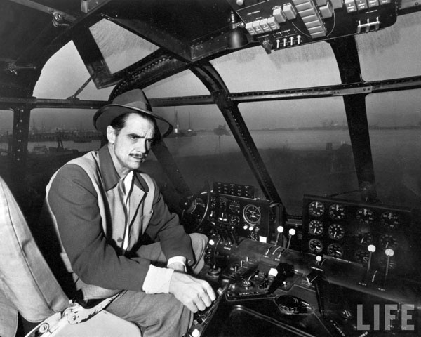 Howard Hughes in cockpit of H4 Hercules plane by J.R. Eyerman.