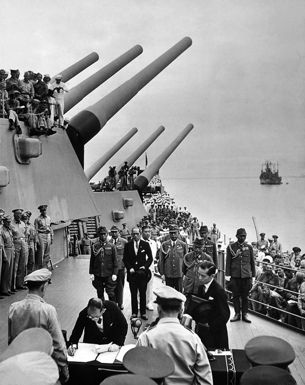 Japanese sign surrender documents on USS Missouri, ending WWII. Photo by LIFE photographer Carl Mydans.