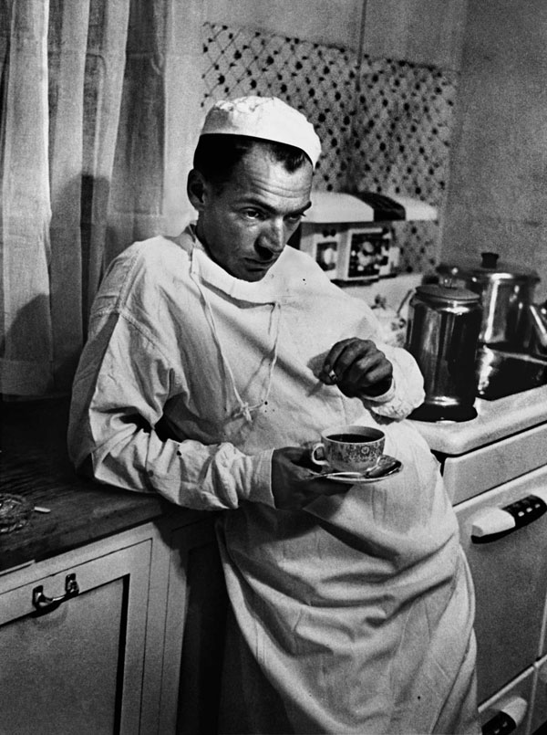 Surgeon stands in hospital kitchen by LIFE photographer W. Eugene Smith.