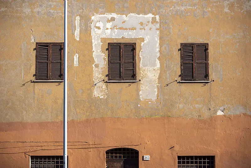 Exterior of a yellow and orange building on a sunny afternoon in Rome, Italy, 2022.
