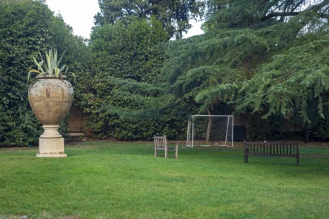 A football goal, plant in a gigantic vase and benches on a lawn in Rome, Italy, 2022.