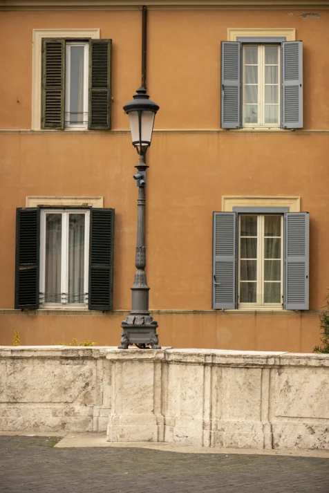 A building, streetlight and surveillance cameras at Piazza di Spagna in Rome, Italy, 2022.