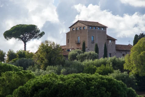 A building and lush foliage on a sunny afternoon in Rome, Italy, 2022.