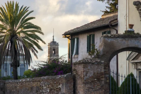 Buildings, a palm tree and a tower in Rome, Italy, 2022.