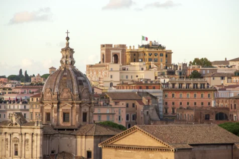 A domed church, buildings and Italian flag in the distance in Rome, Italy, 2022.