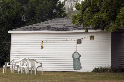 A clothesline, shed and plastic chairs in Jamestown, Rhode Island, 2014.