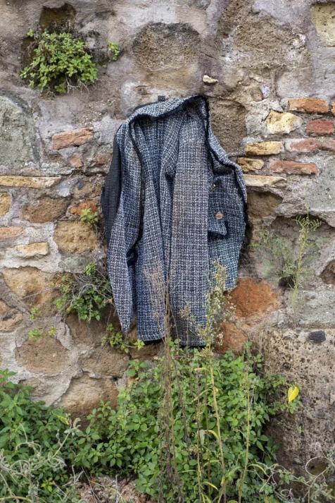 A discarded jacket hangs on a wall at the Giardino degli Aranci in Rome, Italy, 2022.