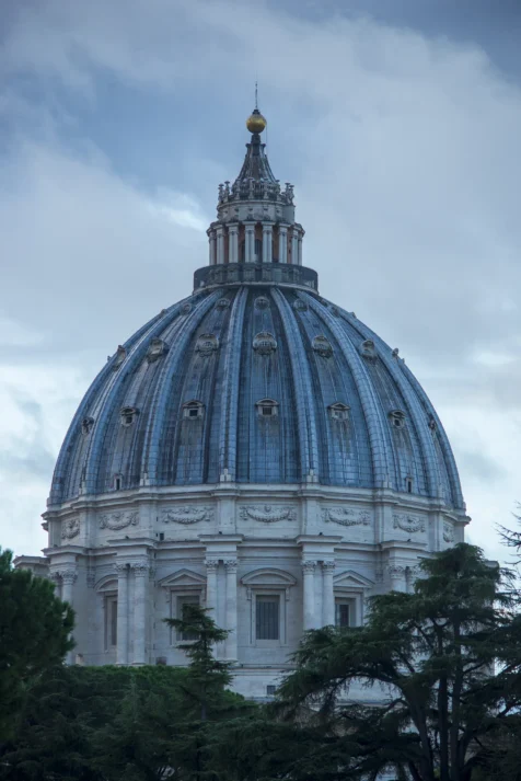 The dome of St. Peter's Basilica on a cloudy morning in Vatican City, 2022.