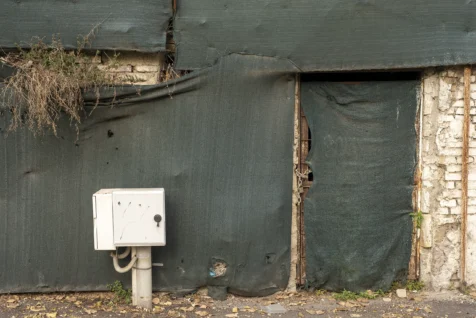 An electric box and padlocked building in Rome, Italy, 2022.