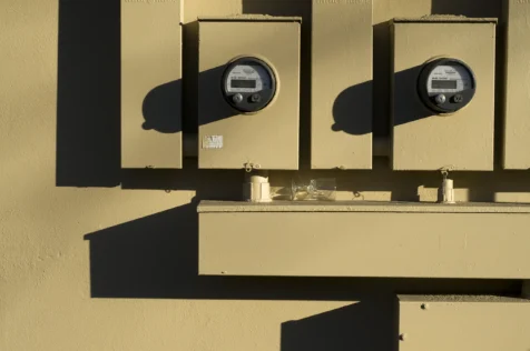 Electric meters and an overturned glass in Nyack, New York, 2016.
