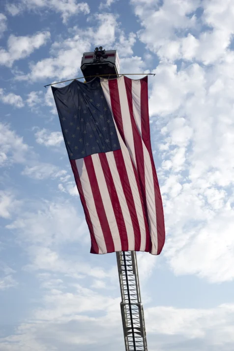 A giant American flag hangs from fire truck ladder in Pomona, New York, 2016.