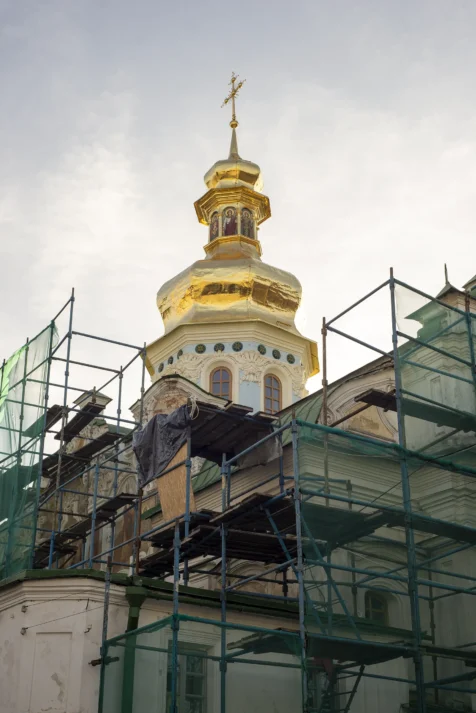 A golden domed tower and ongoing construction at Kyiv Pechersk Lavra, 2019.