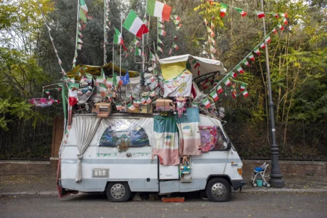 A mobile home adorned with many Italian flags in Rome, Italy, 2022.