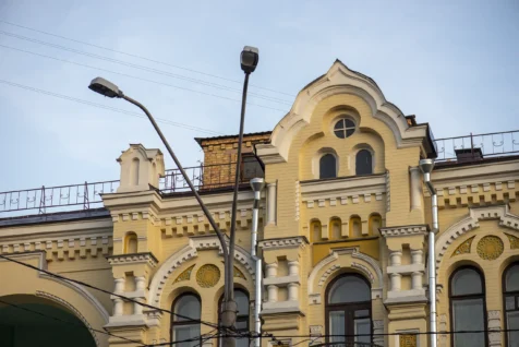 An old yellow building and streetlights in Kyiv, Ukraine, 2019.