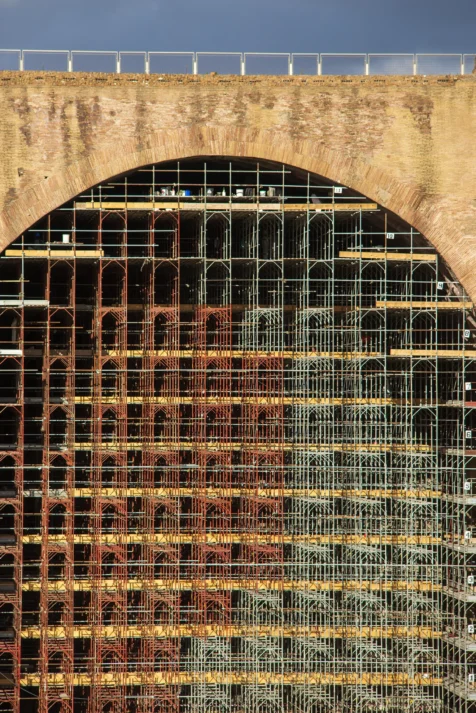 Red and white scaffolding near the Basilica of Maxentius in Rome, Italy, 2022.