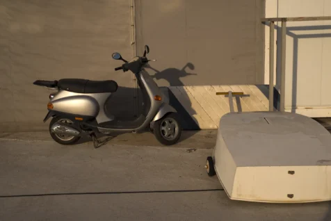 A scooter in a boatyard at dusk in Split, Croatia, 2019.