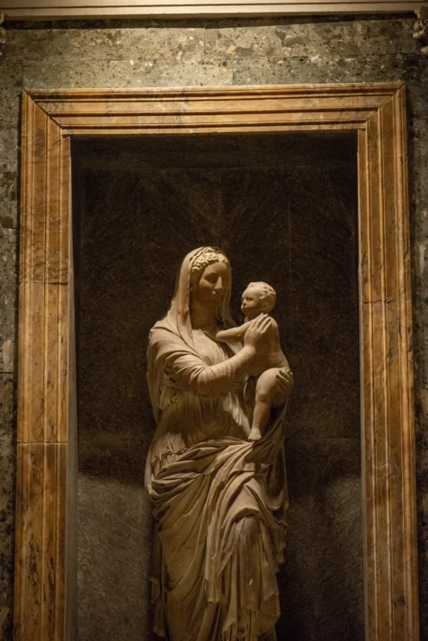 A framed sculpture of a woman and baby at the Pantheon in Rome, Italy, 2022.