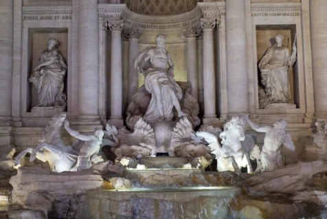 Sculptures at the Trevi Fountain at night in Rome, Italy, 2022.