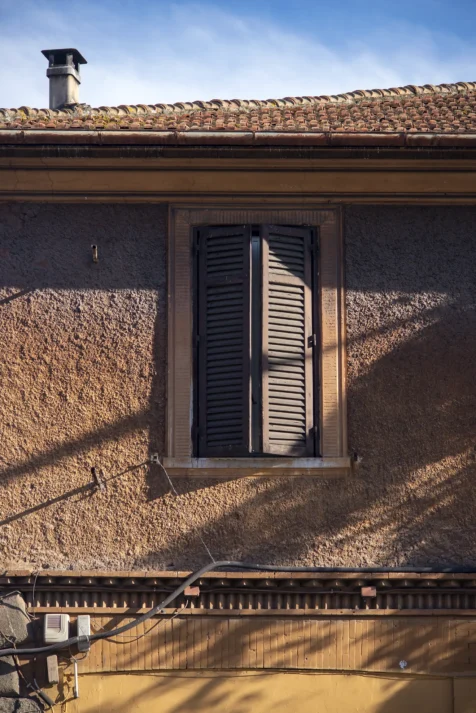 A shuttered window on a sunny afternoon in Rome, Italy, 2022.