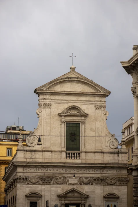 A simple cross on a church in Rome, Italy, 2022.