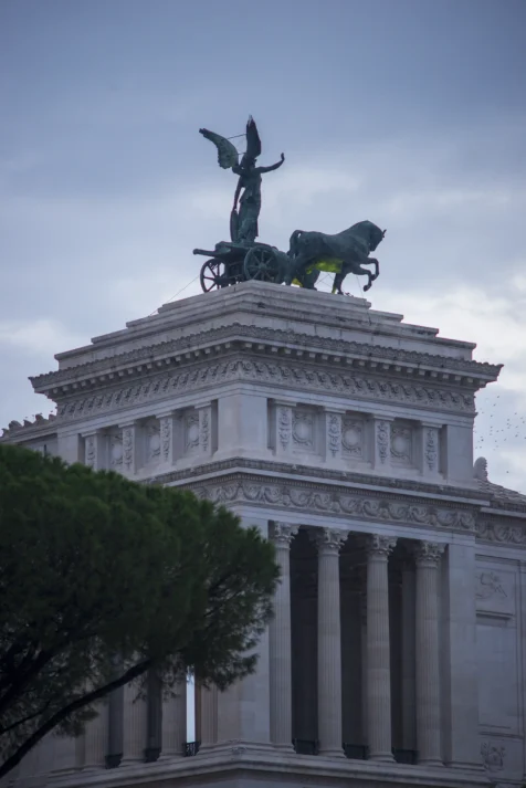 Statues atop Il Vittoriano at dusk in Rome, Italy, 2022.