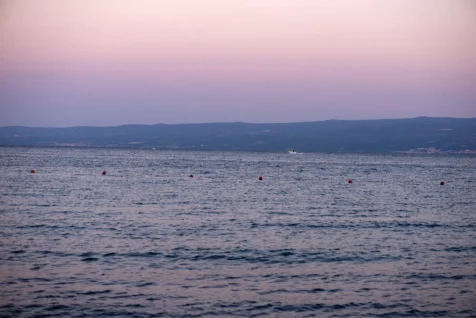 A lone boat in the Mediterranean Sea at dusk, captured from Split, Croatia, 2019.