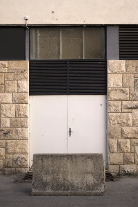 White double doors and concrete barrier in Split, Croatia, 2019.