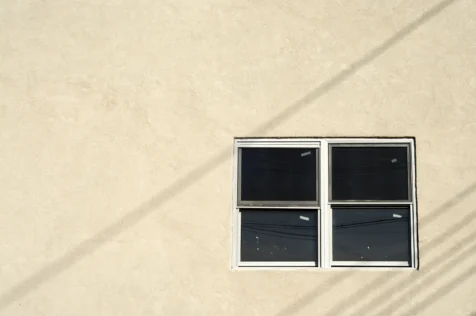 Windows and diagonal shadows on building exterior in Nyack, New York, 2014.