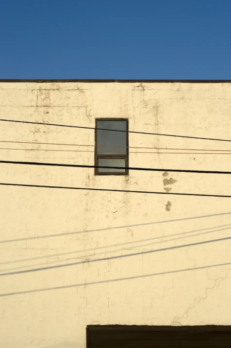Power lines and building exterior on a sunny day in Nyack, New York, 2014.