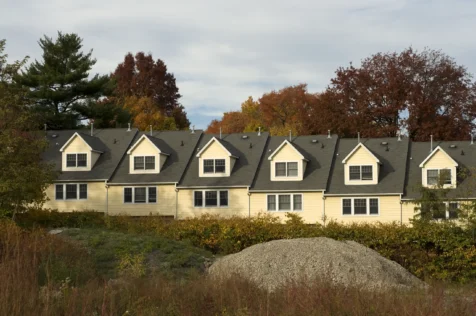 A row of yellow townhouses and pile of rocks in Nyack, New York, 2015.