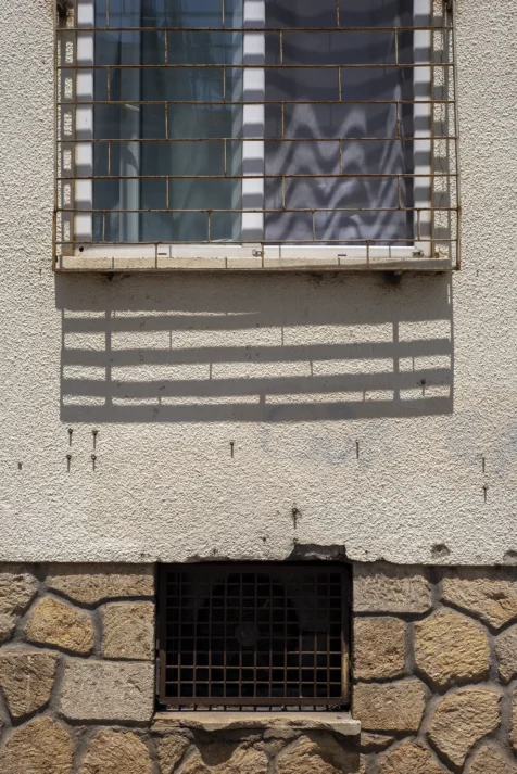A barred window and shadows in Old Town, Antalya, Turkey, 2023.