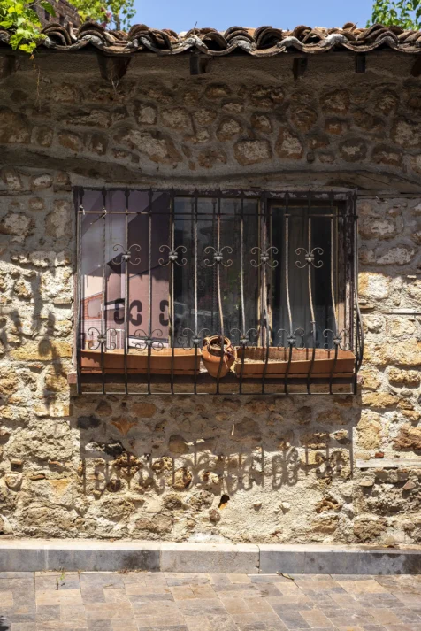 A barred window and shadows in Old Town, Antalya, Turkey, 2023.