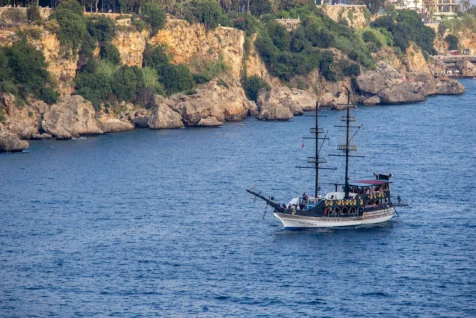 A boat near the rocky cliffs of Antalya, Turkey, 2023.