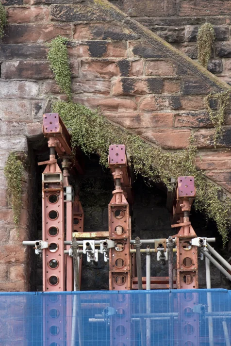 Metal pylons under a staircase on the ancient Roman wall in Chester, England, 2017.