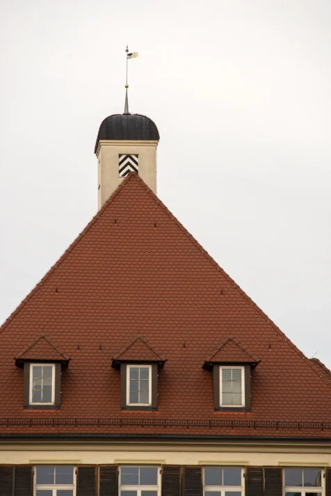A building with a reddish roof and tower in Ulm, Germany, 2023.
