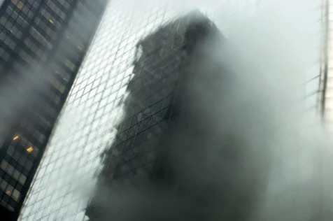 A building reflected in skyscraper windows on 49th Street in New York City, 2014.