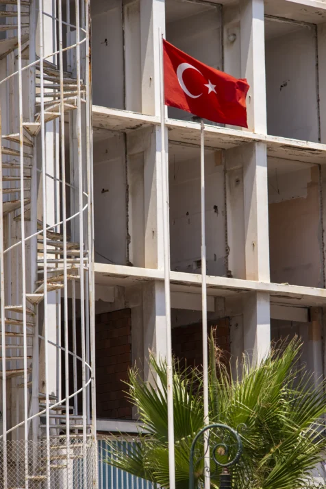 A Turkish flag and building under construction in Antalya, Turkey, 2023.