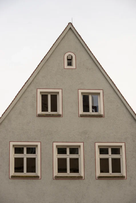 A grey building with windows at dusk in Ulm, Germany, 2023.