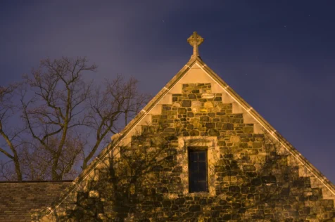 Long exposure of a church rectory illuminated by streetlights at night in Nyack, New York, 2014.