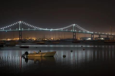 Long exposure of the Claiborne Pell Newport Bridge and boats in Narragansett Bay at night in Jamestown, Rhode Island, 2014.