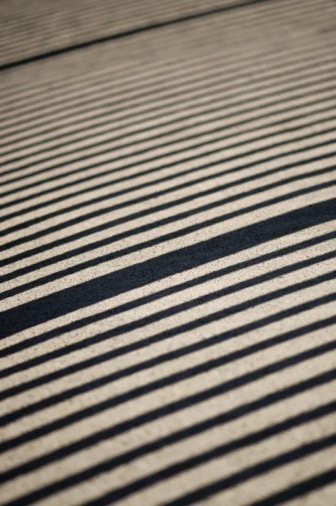 Diagonal shadows on concrete near the Delaware River in upstate New York, 2014.