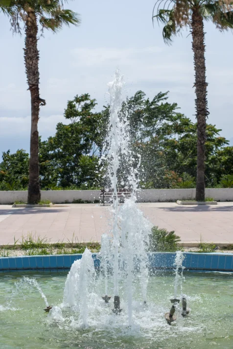 A fountain and pair of palm trees at a park in Antalya, Turkey, 2023.