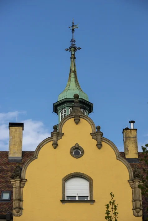 A funky yellow building and vibrant blue sky in Lindau, Germany, 2023.