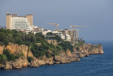 Buildings under construction and cliffs near the Mediterranean Sea in Antalya, Turkey, 2023.