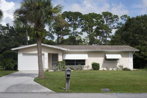 A light house and palm tree in the front yard in Port Saint Lucie, Florida, 2016.