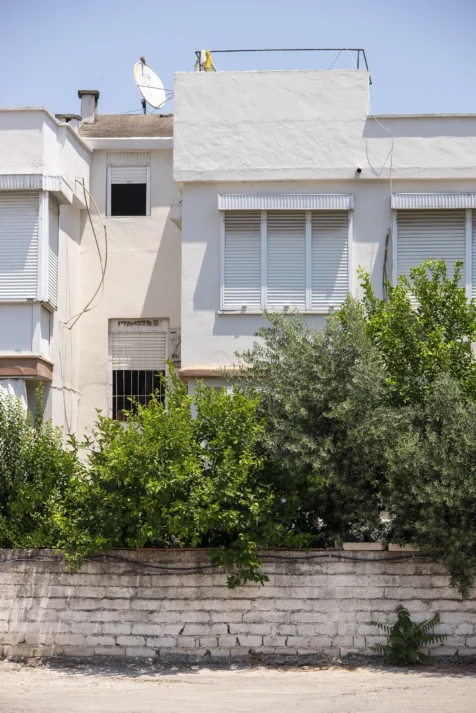 A white building, brick wall and plants in Antalya, Turkey, 2023.