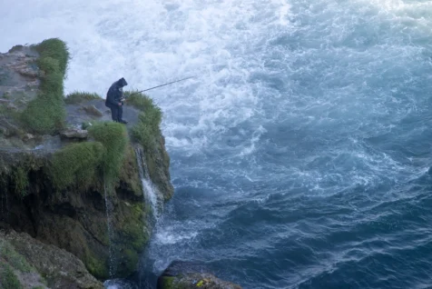 A man fishes near the Duden Waterfalls in Antalya, Turkey, 2023.