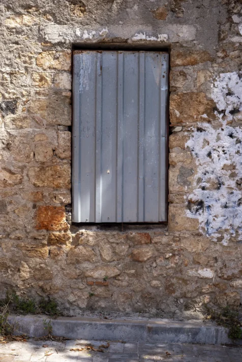 A metal sheet covers a window in Old Town, Antalya, Turkey, 2023.