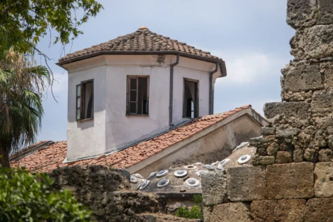 An old building, rock wall and tree in Antalya, Turkey, 2023.